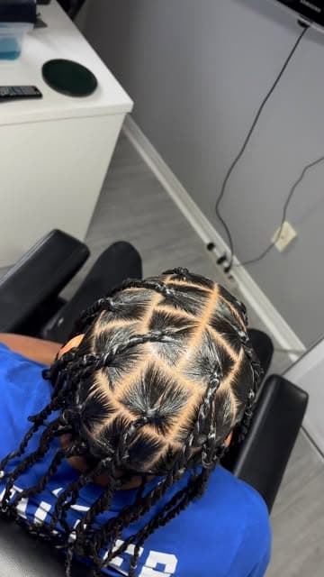 Straight-back cornrows with braided lengths left loose.