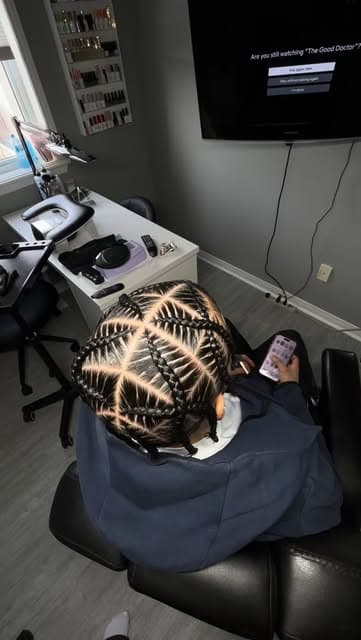 A finished cornrow set photographed in the home studio chair.