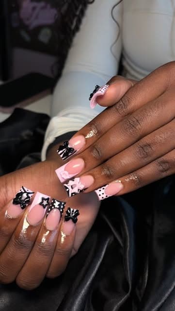 Black and white nails finished with 3D stars and charms.