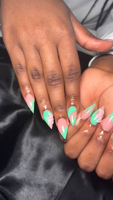 Mint green stiletto nails with a glossy french finish.