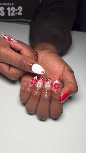 Red, white and pink nails with heart nail art and rhinestones.